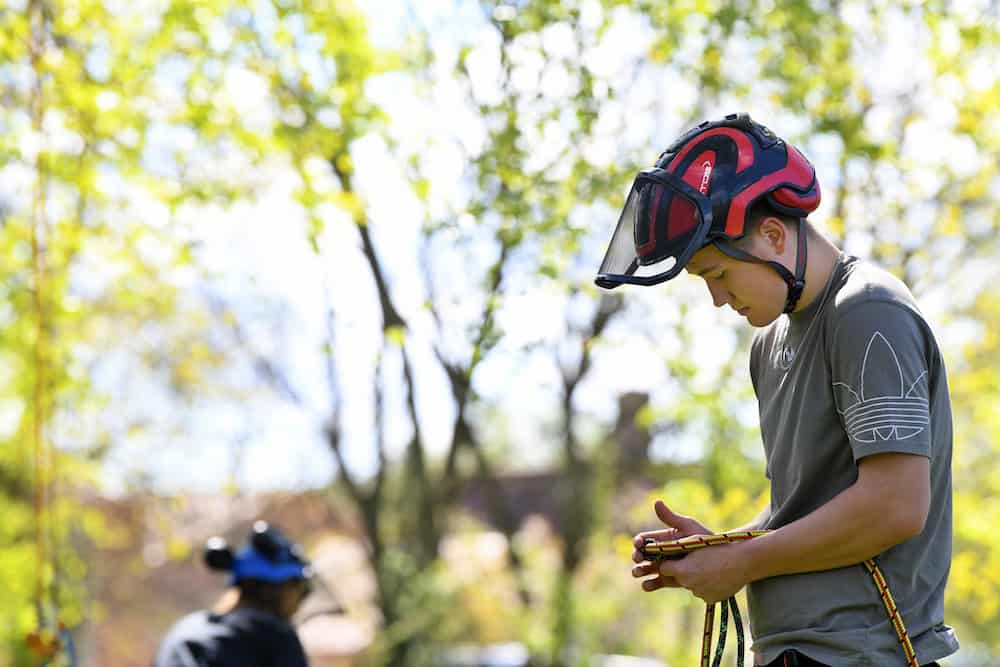 Learner wearing PPE holding rope.